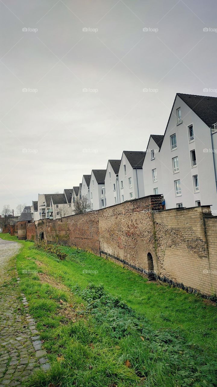 Old city wall and modern buildings