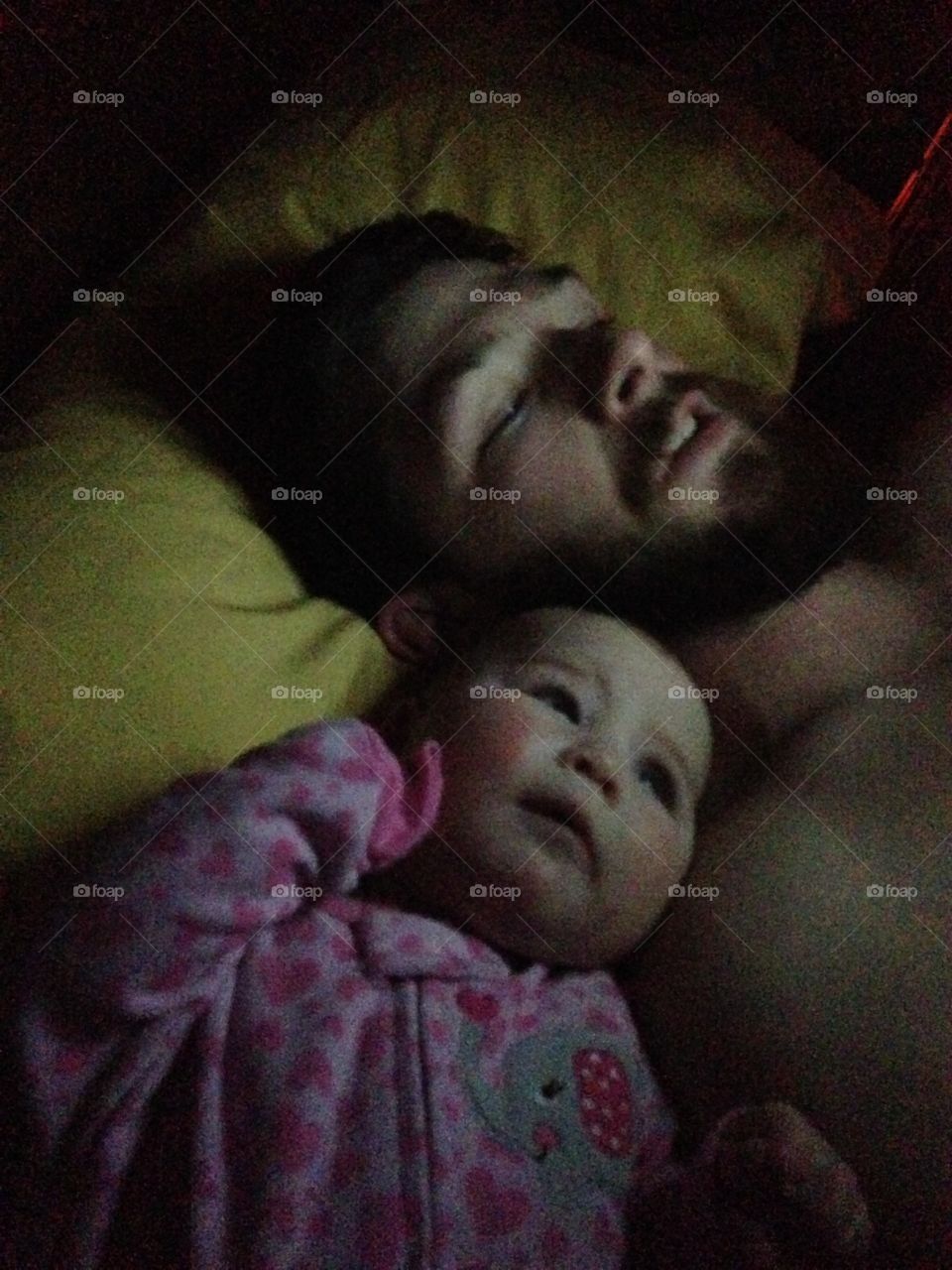 Cute daughter sleeping with his father