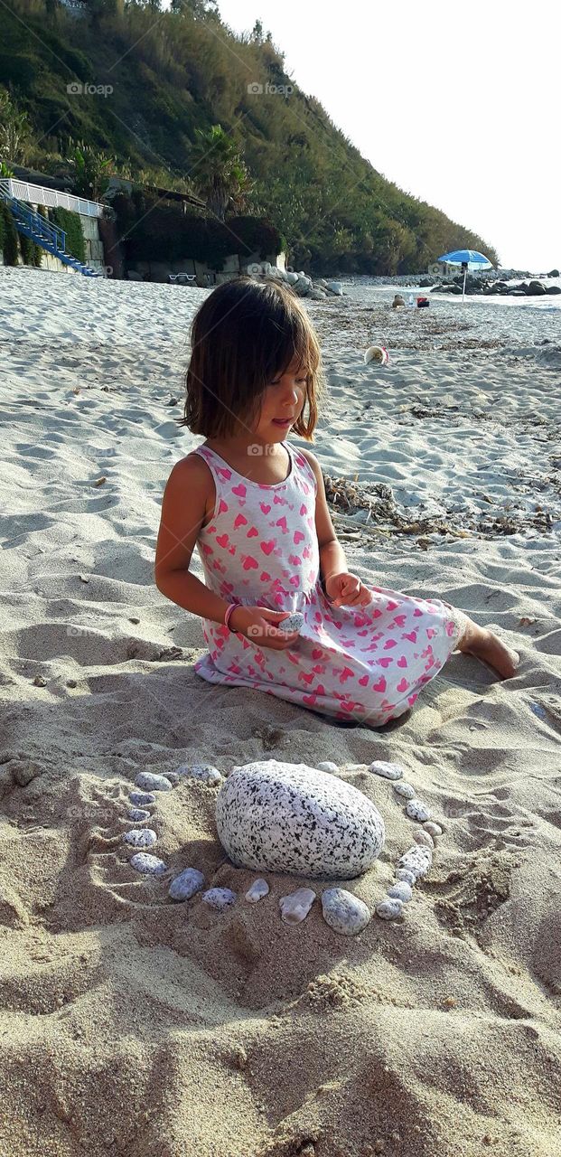 Little girl playing on the beach