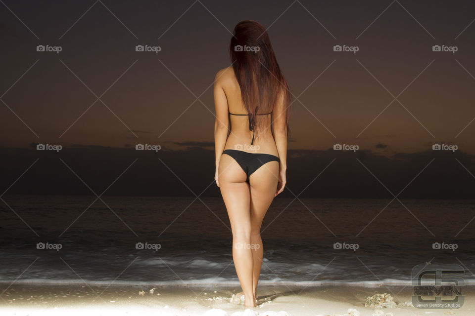 Rear view of a woman walking on beach