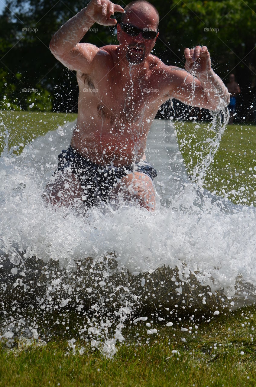 Mature man splash water in lake