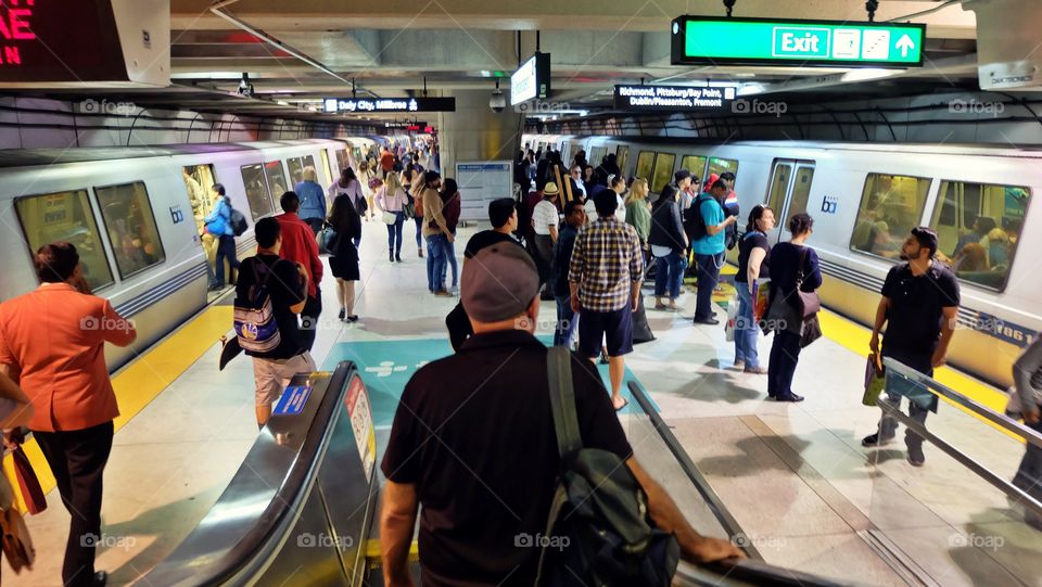 Commuters getting ready to get on the trains and commute home from work.