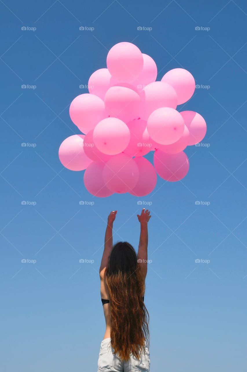 Girl with pink balloons 
