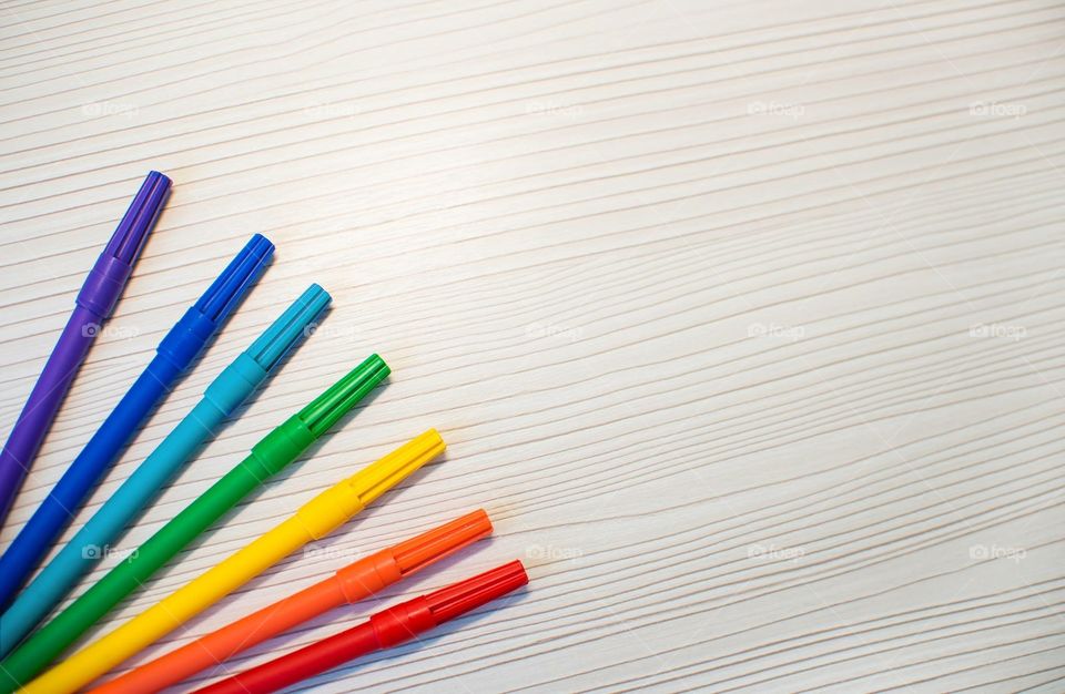 Multicolored Markers On A Wooden Background