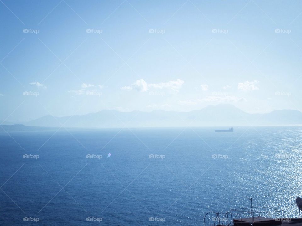 Ship in the ocean with mountains in the bacground