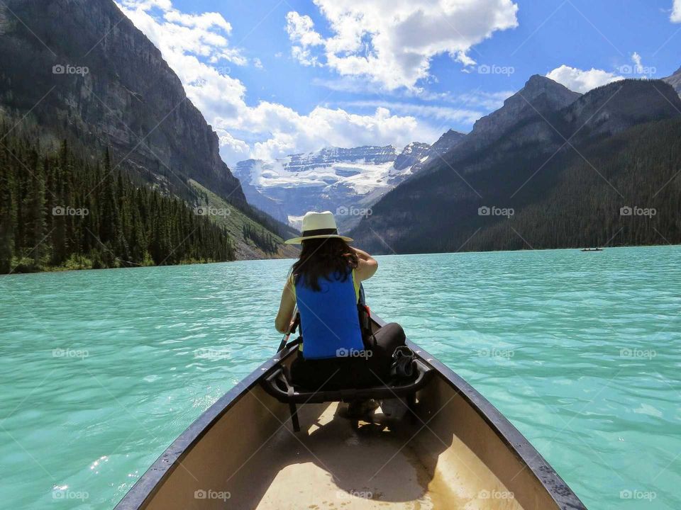 Woman canoeing in green water