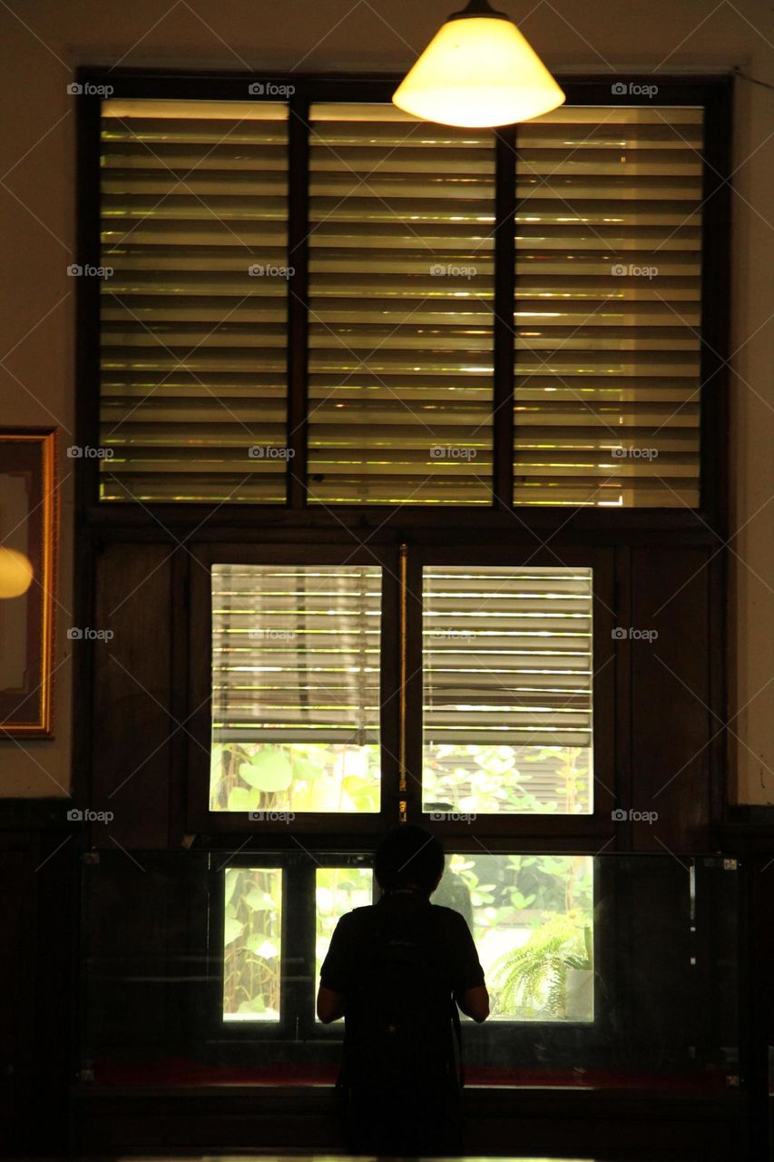 A portrait of a typical Dutch colonial legacy from an old building, namely windows in a typical European style.