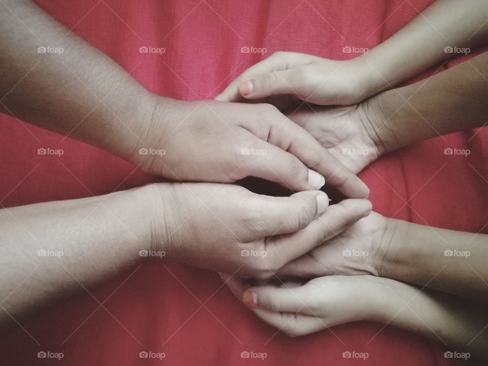 Close-up of mother with child holding hands