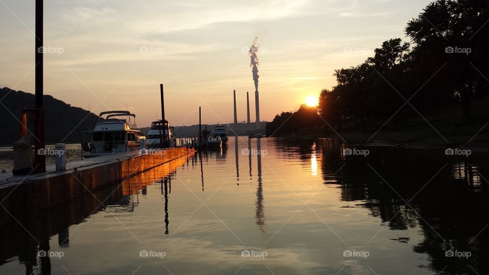 the river at sunset. boats at dock