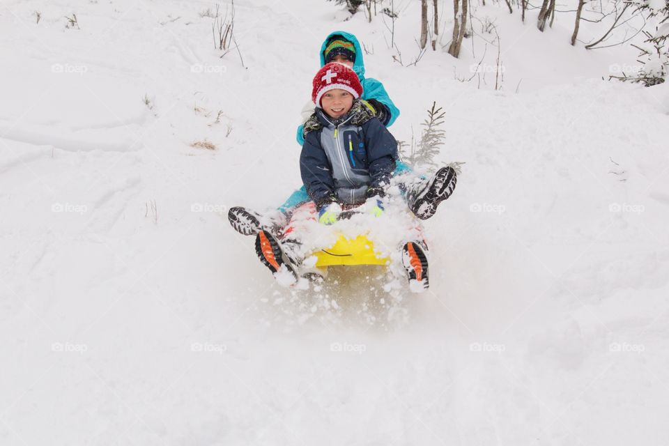 Young Boys Enjoying A Sleigh Ride.