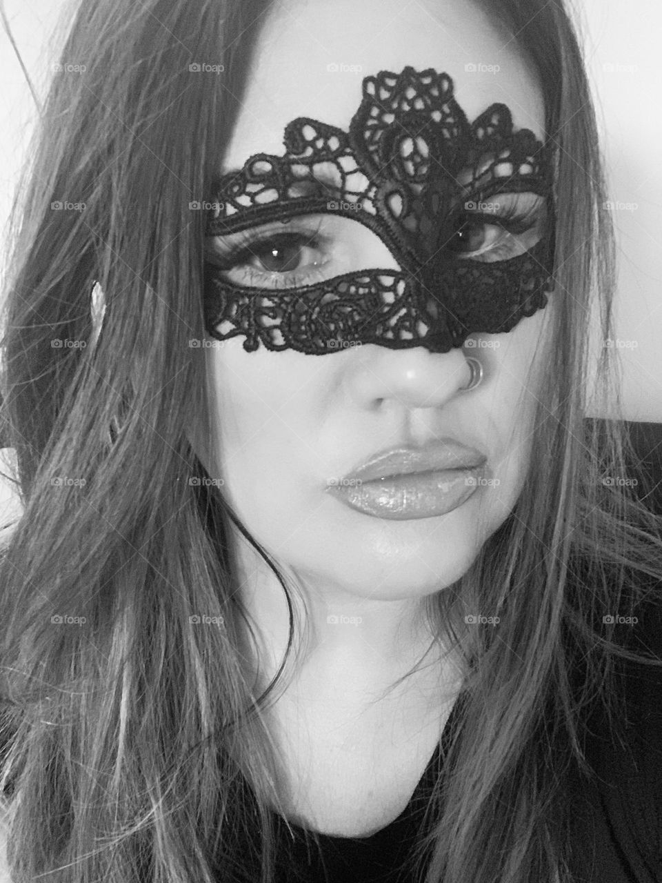 Black & White picture of a woman wearing a mask at a costume party! 