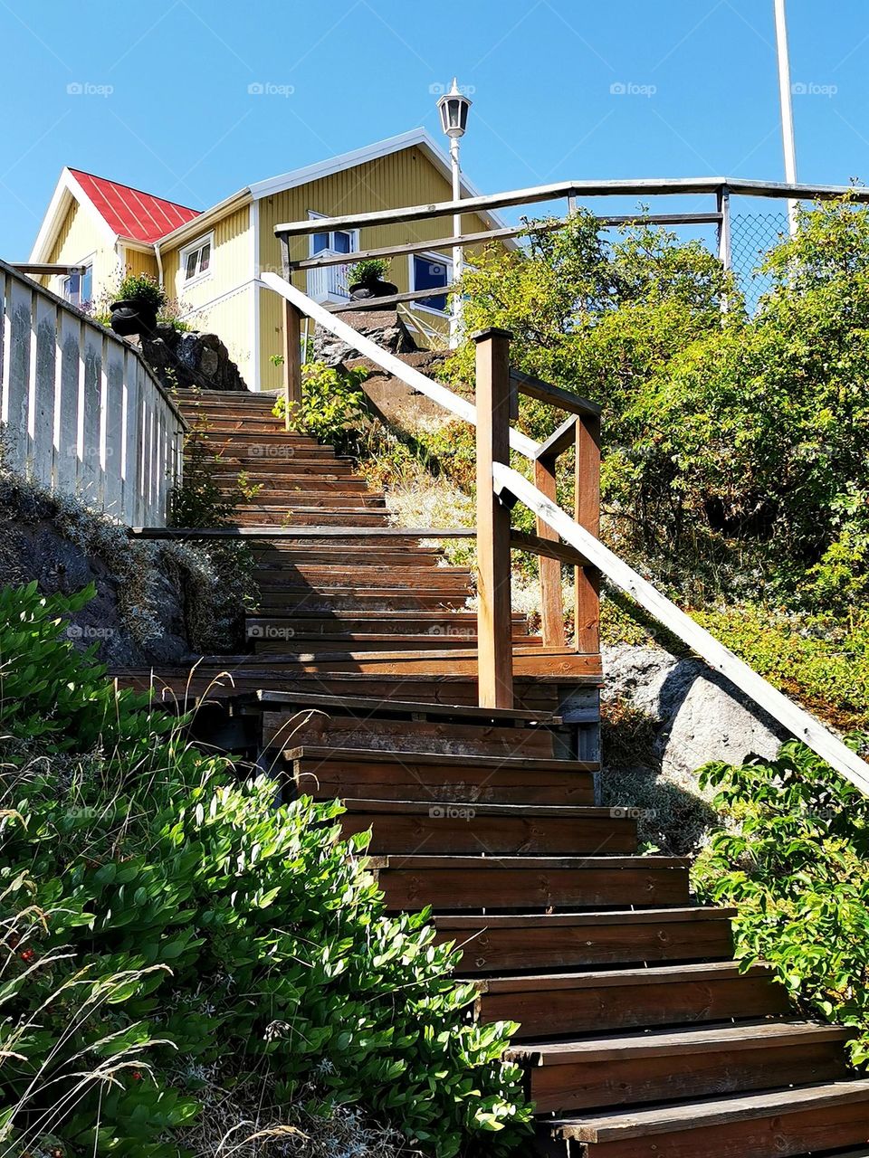 Stairs up to yellow house