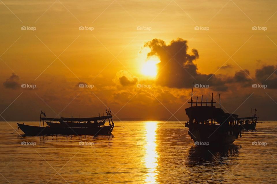 Long boats at sunrise on the island of Koh Rong, Cambodia 