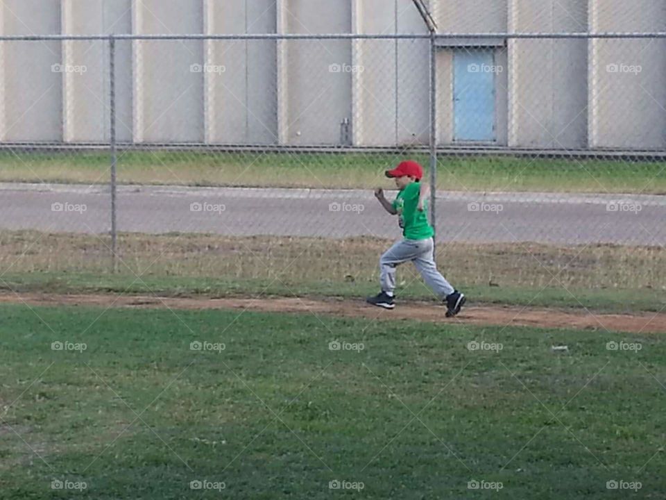 Running to first . my son running to first base 