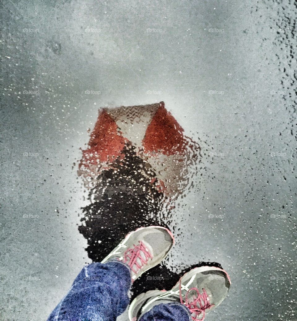 Me and my umbrella reflected in a puddle
