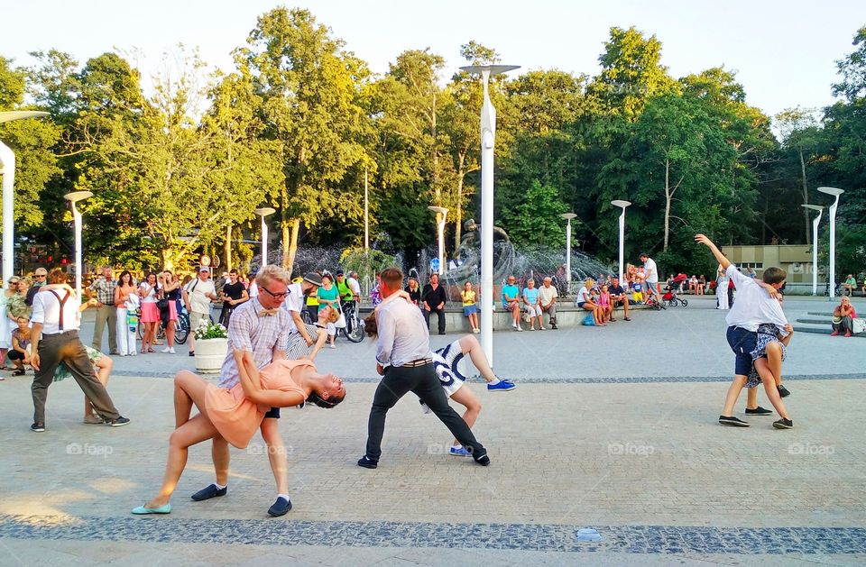 young people dancing in the town square