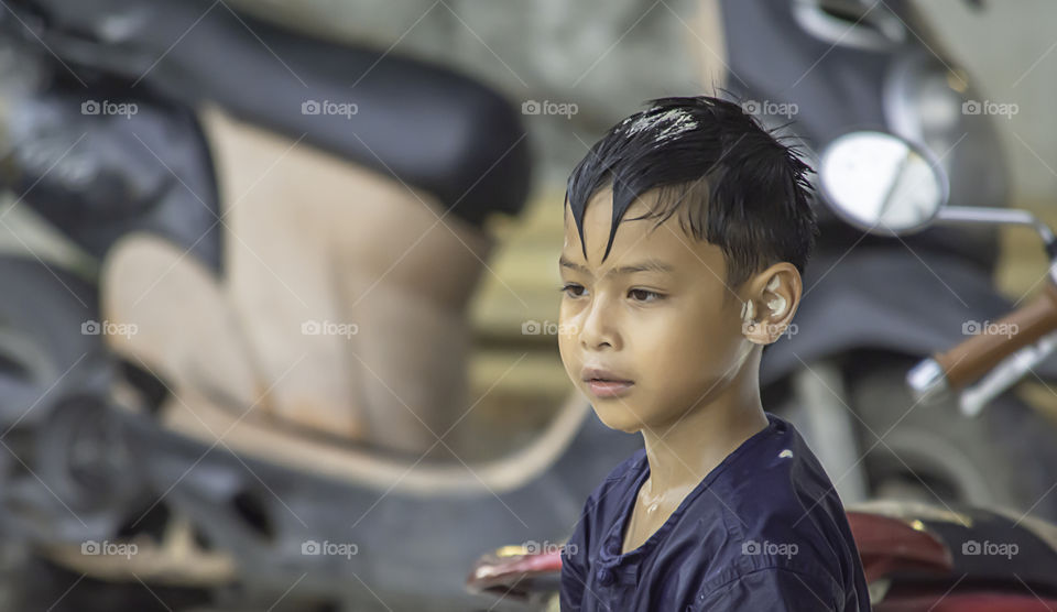 Asian boy play water and flour in Songkran festival or Thai new year in Thailand.