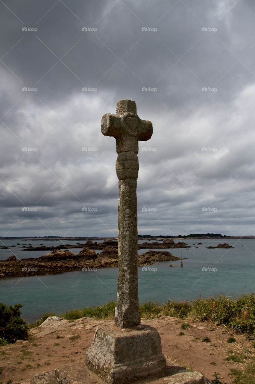 stone cross on the background of blue sky