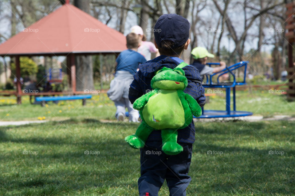 Kid on the playground . photographed from behind