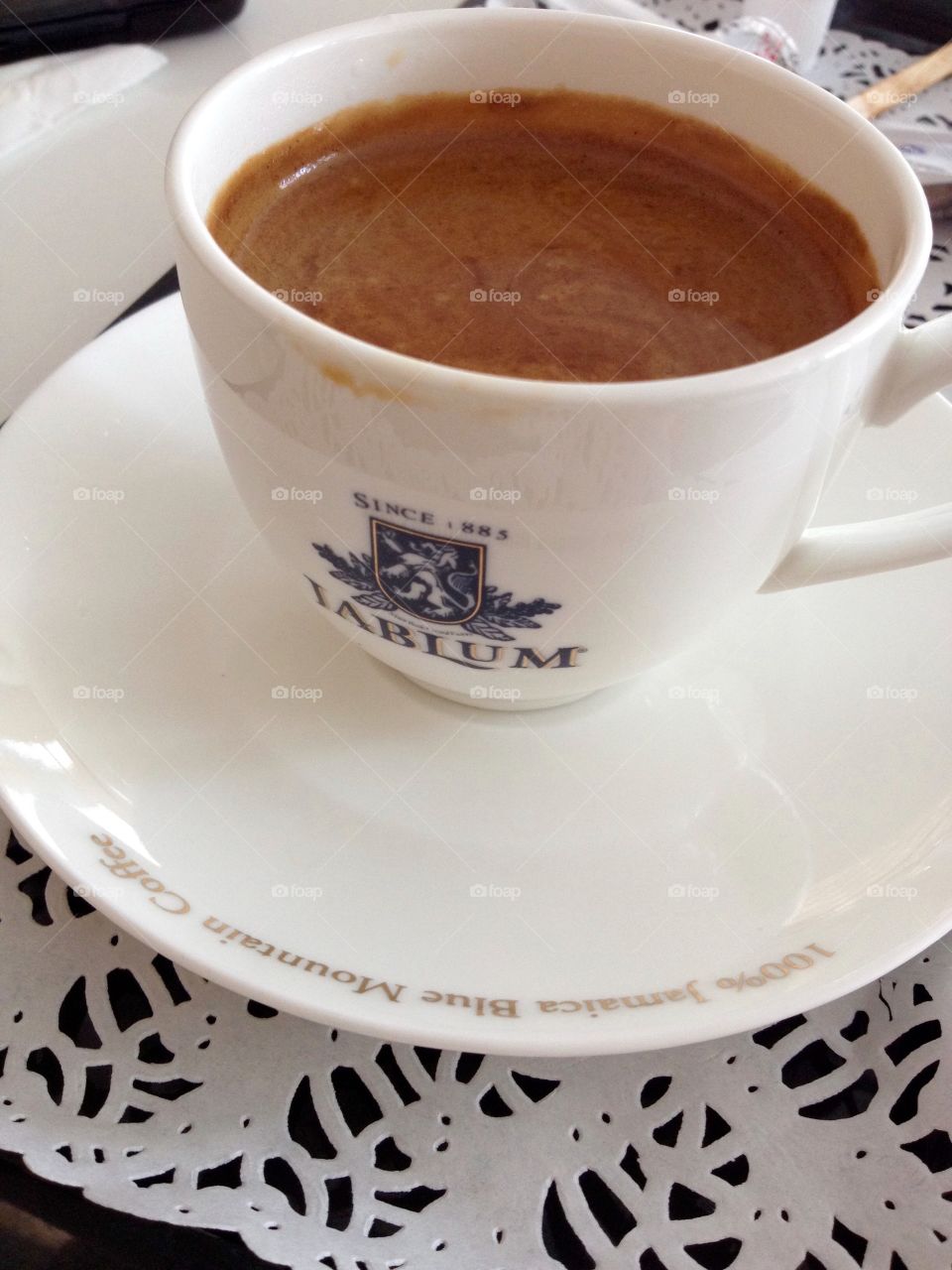 A cup of coffee on a table cloth 