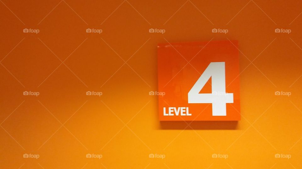 A sign stating Level 4 on an orange background.
