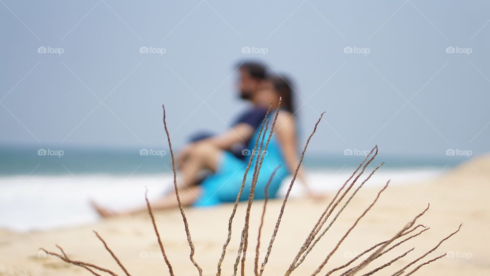 A couple having a quality time together  at  Varkala beach in Kerala.