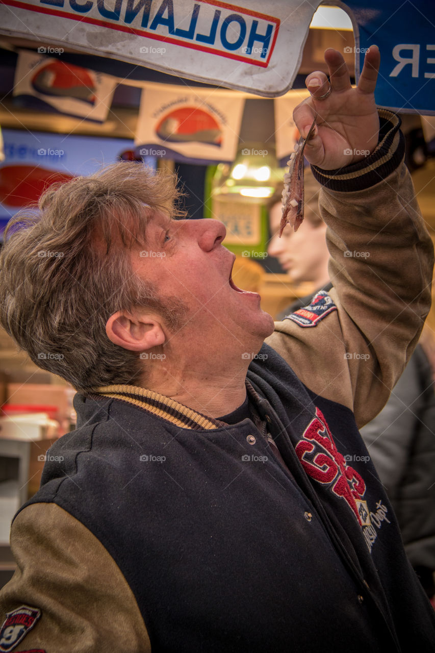 When it is new herring season in the Netherlands the crowd lines up to get the first of the season...this is the traditional way to eat them 