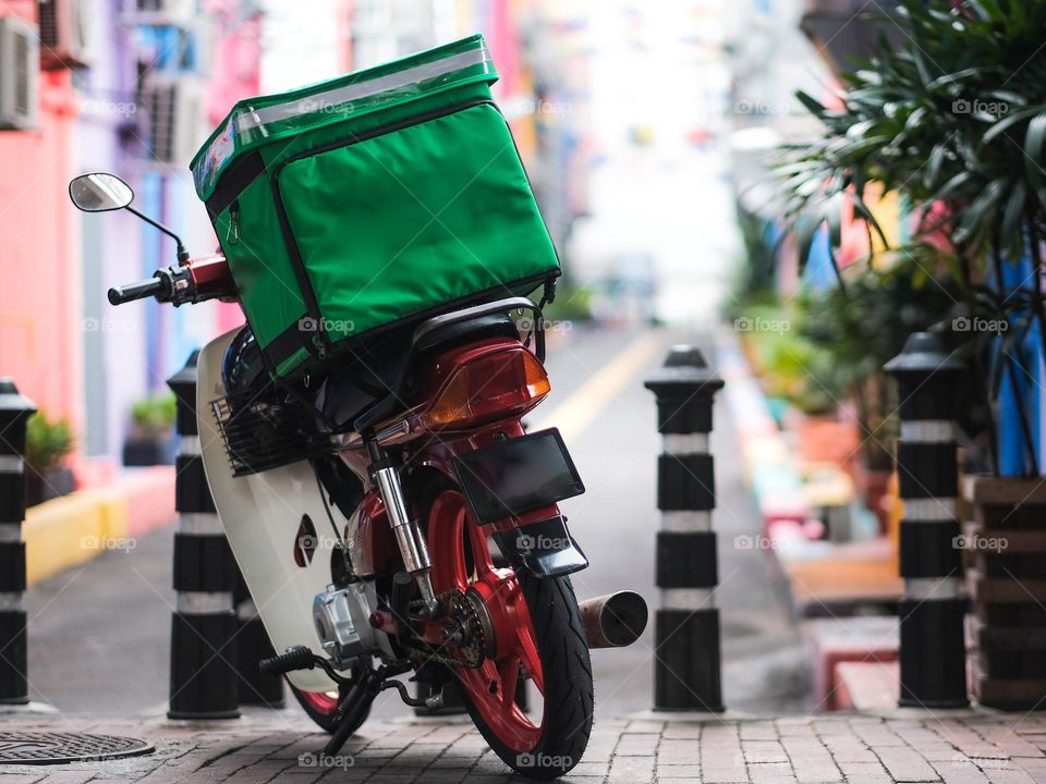 A Food Panda delivery scooter parked on the street of Kuala Lumpur, Malaysia