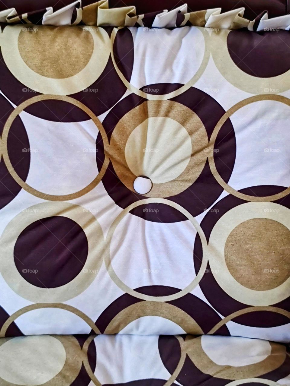 the fabric of the sofa is made up of several circles.