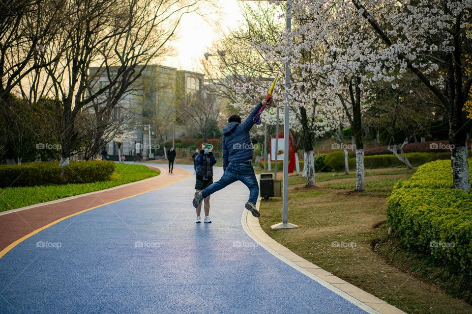 A man is jumping while he is excited