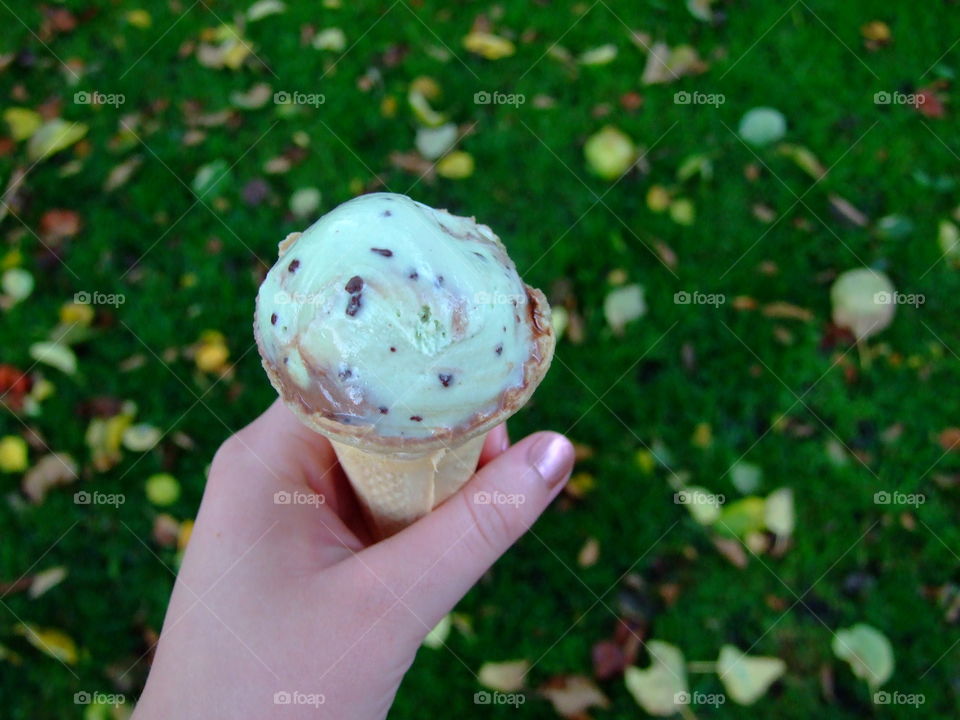 Ice cream cone and green, leafy background