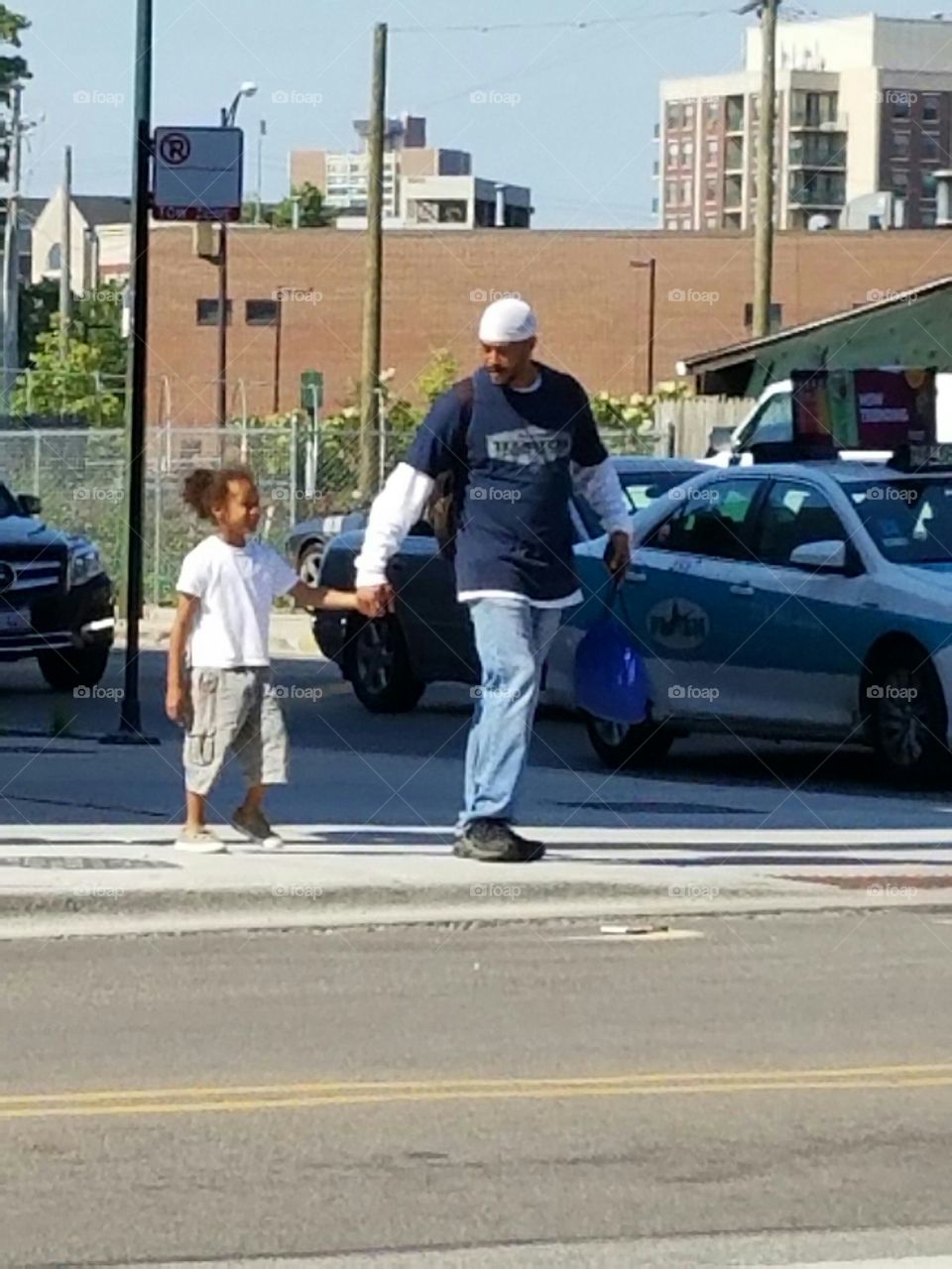 dad and daughter crossing the street