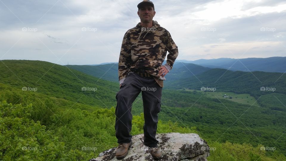 Man standing on top of rock