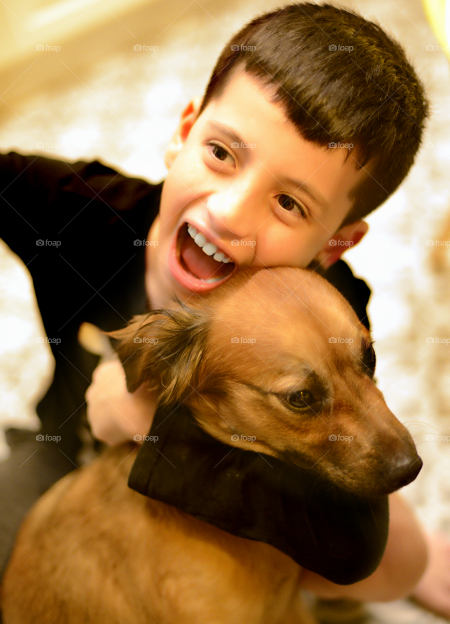 Boy embracing his dog