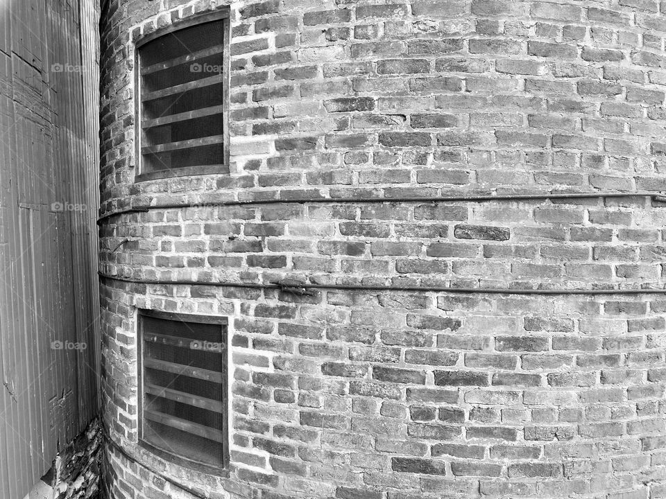 An old silo next to a barn