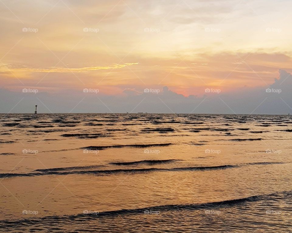 Scenic view of sea against sunset sky