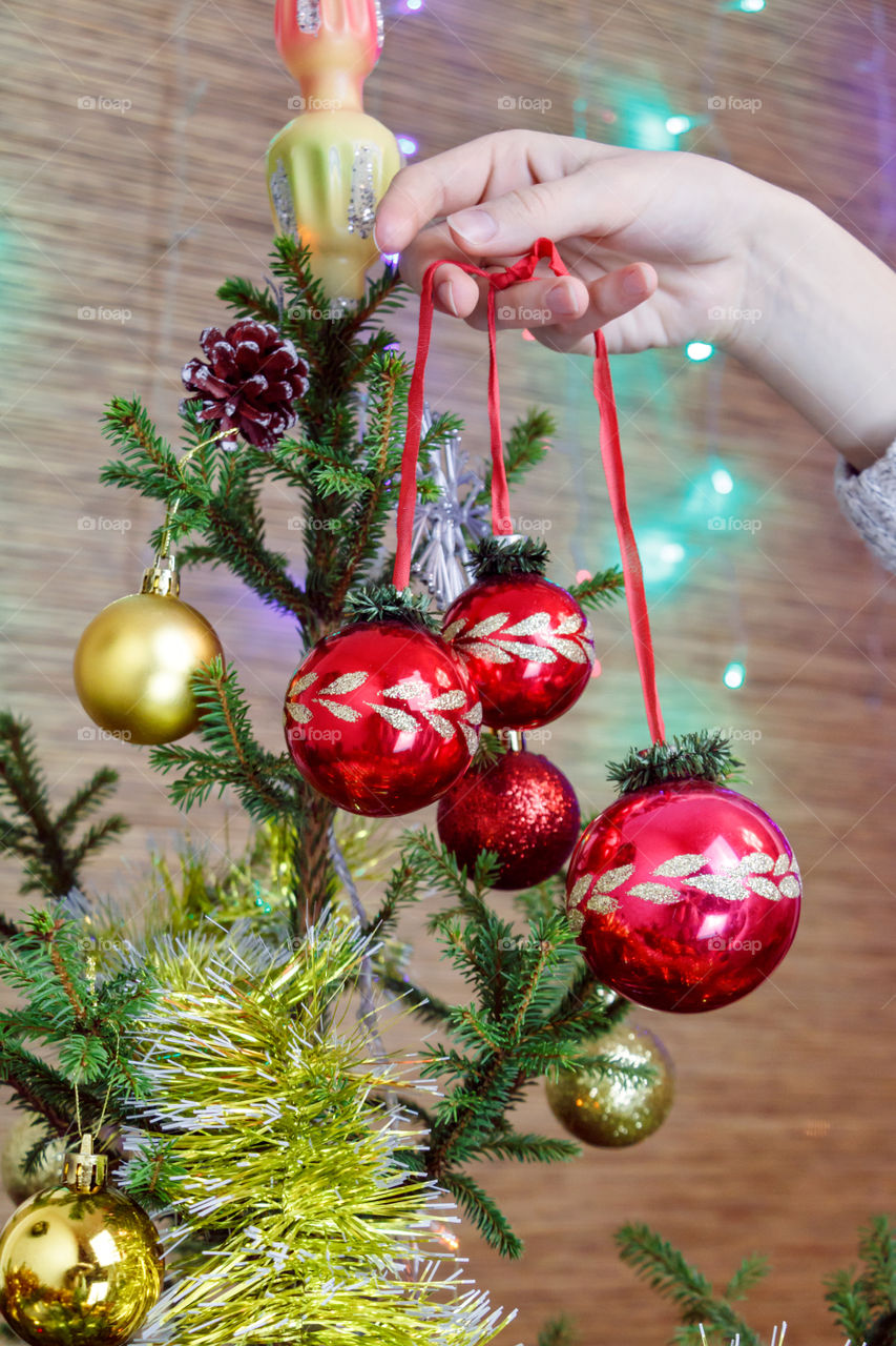 girl is decorating the Christmas tree