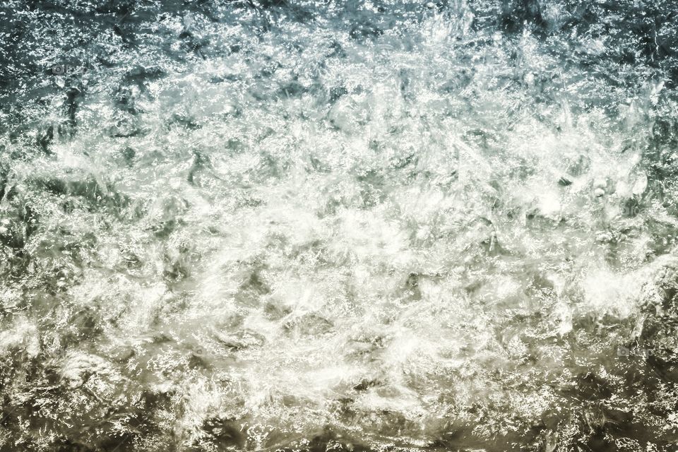 A picture of the water as it is forming small waves. It is edited to make that color change but it is also abstract. 