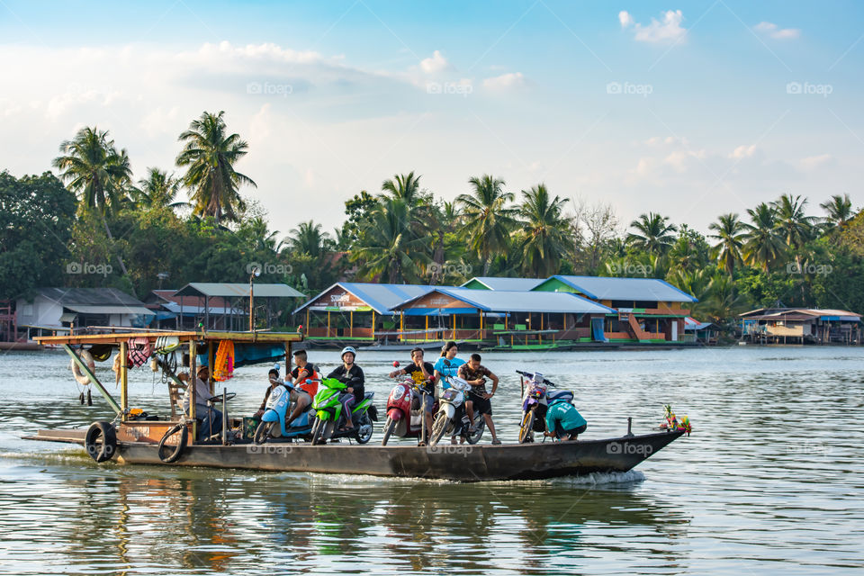 Ship passenger and motorbikes across  Khwae Noi river at Kanchanaburi Thailand.