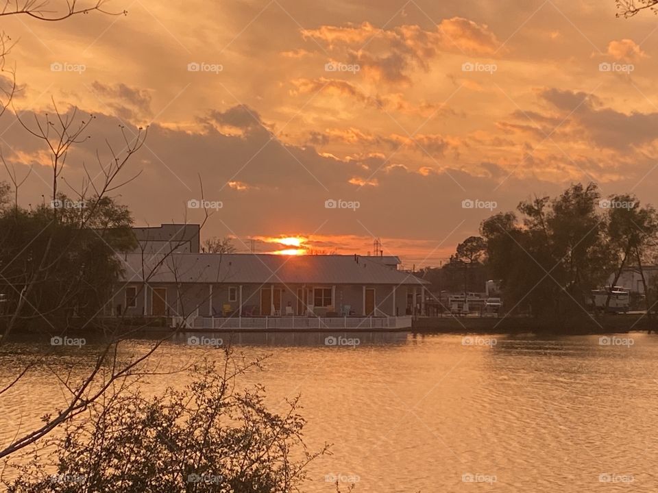 Clouds shroud the sunset. Sun setting taking pieces of the Sun to make this work. 