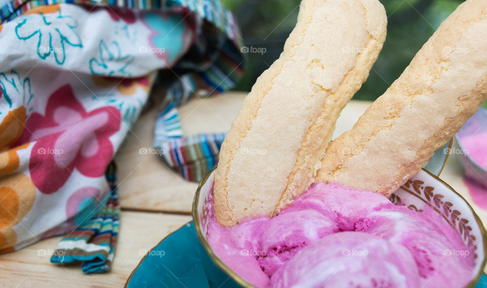 Lady fingers cookies in pink sorbet ice cream