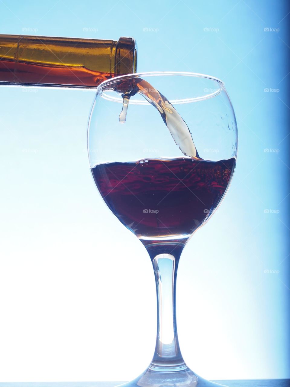 Wine is poured from a bottle into a glass.
