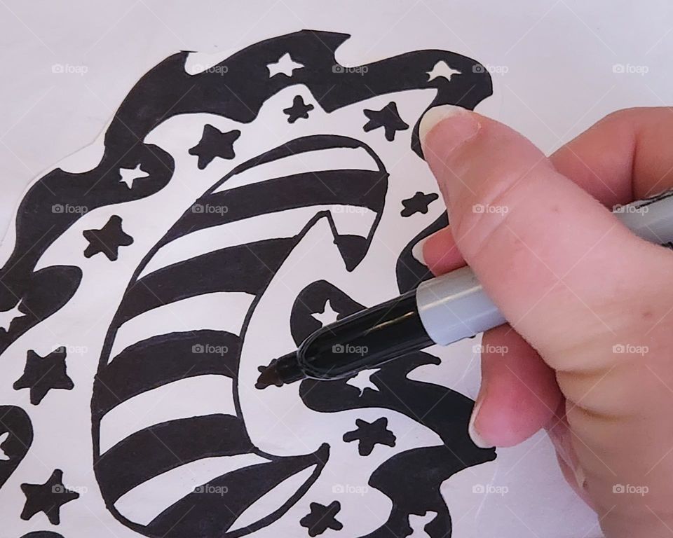 hand drawing a moon and stars design because many of us find inspiration to create in the late night hours