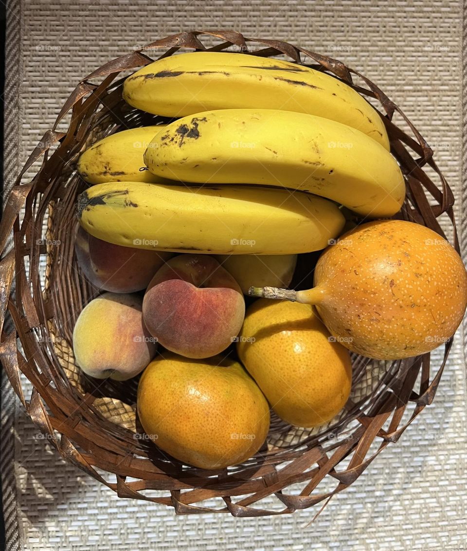 Some yellow fruits in a basket