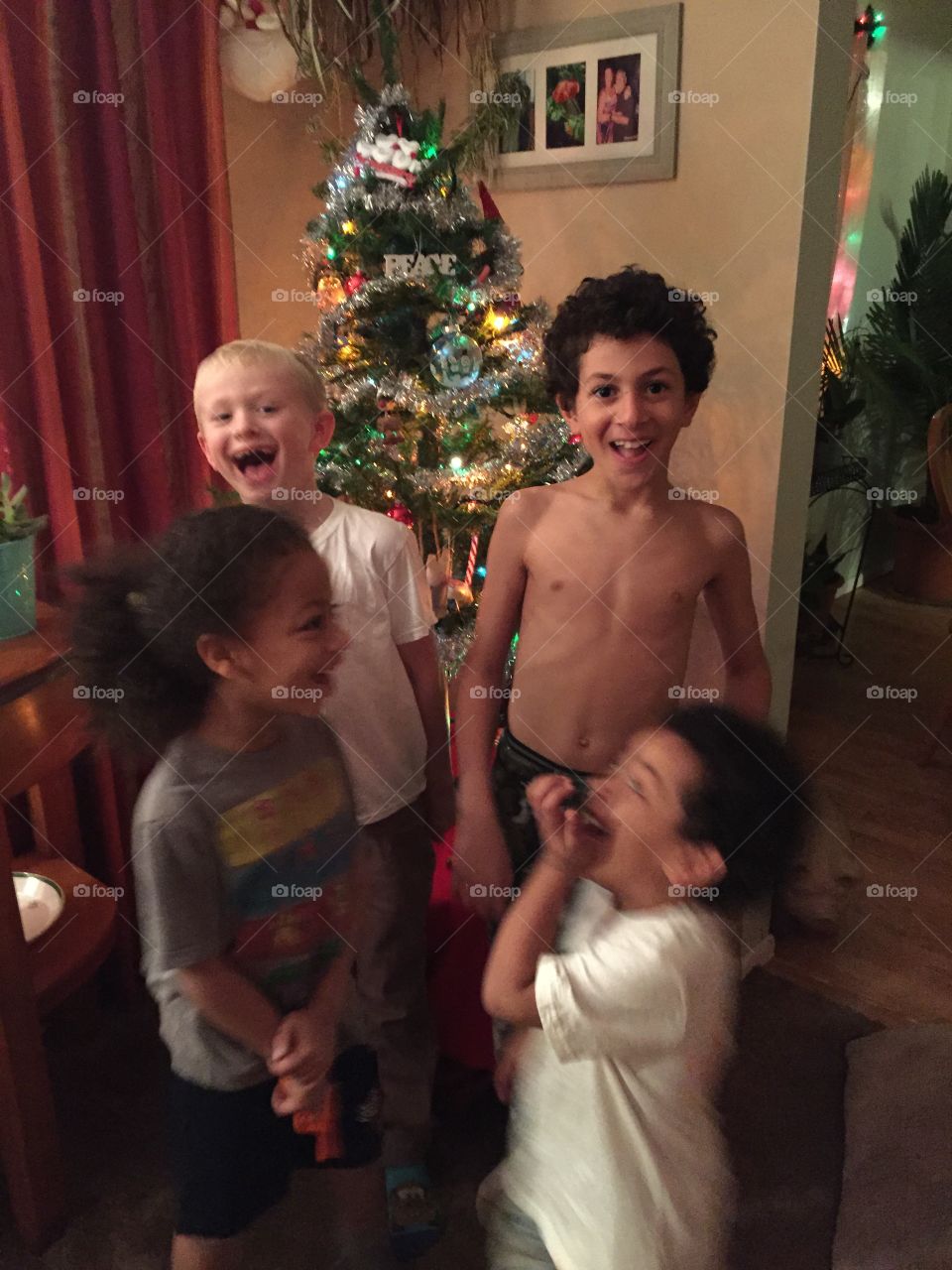 Children celebrating christmas in house