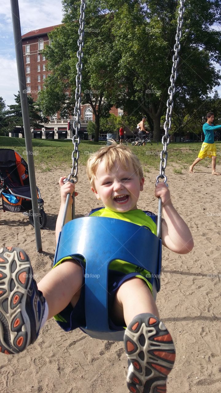 Swinging toddler. my son Zac happily swinging at Lake Calhoun in MN