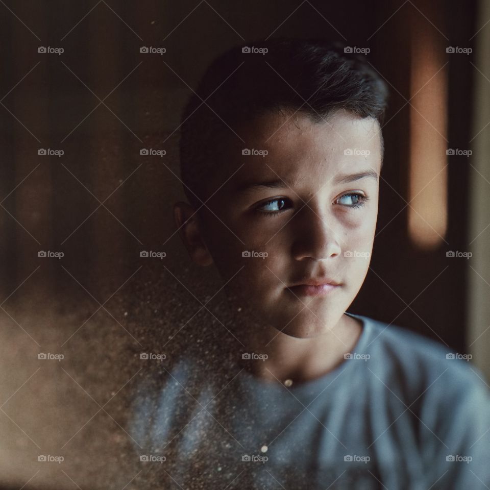 Boy looking through window
