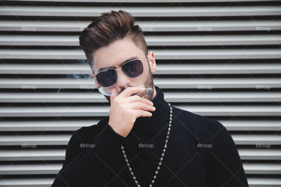 Young man smoking cigar