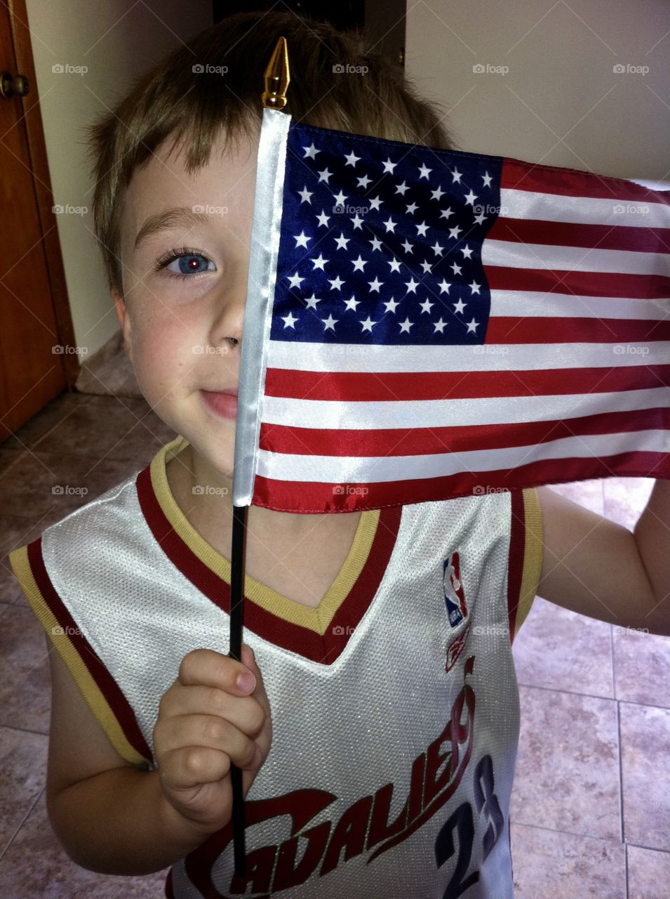 Young child holding a flag 