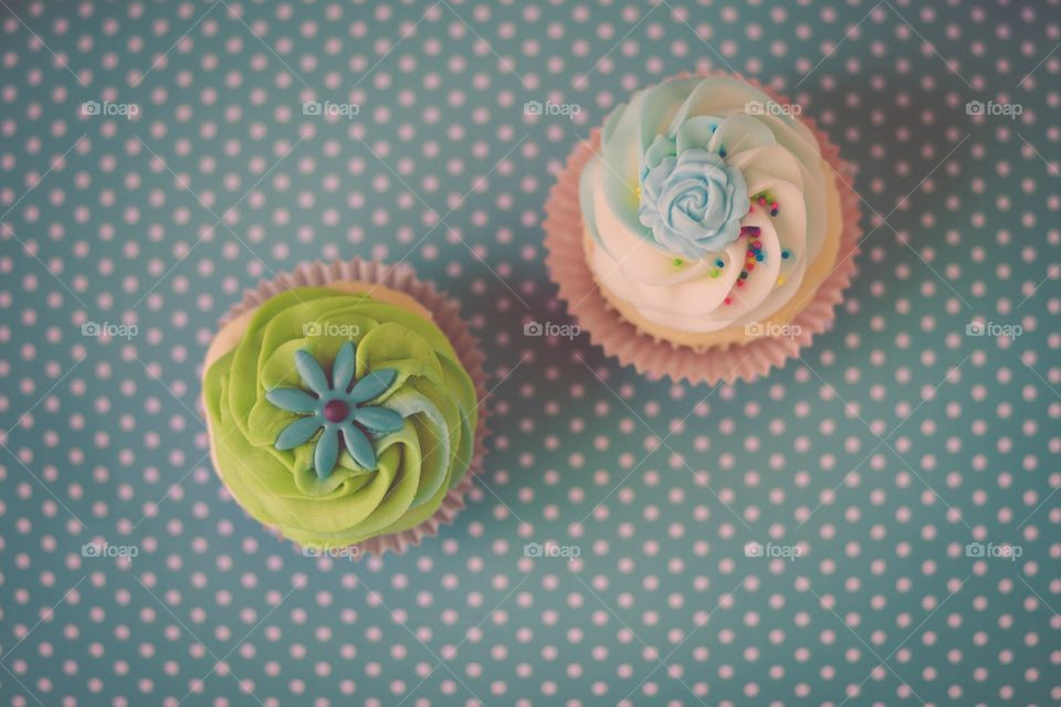 Cupcakes on light blue polka dot background